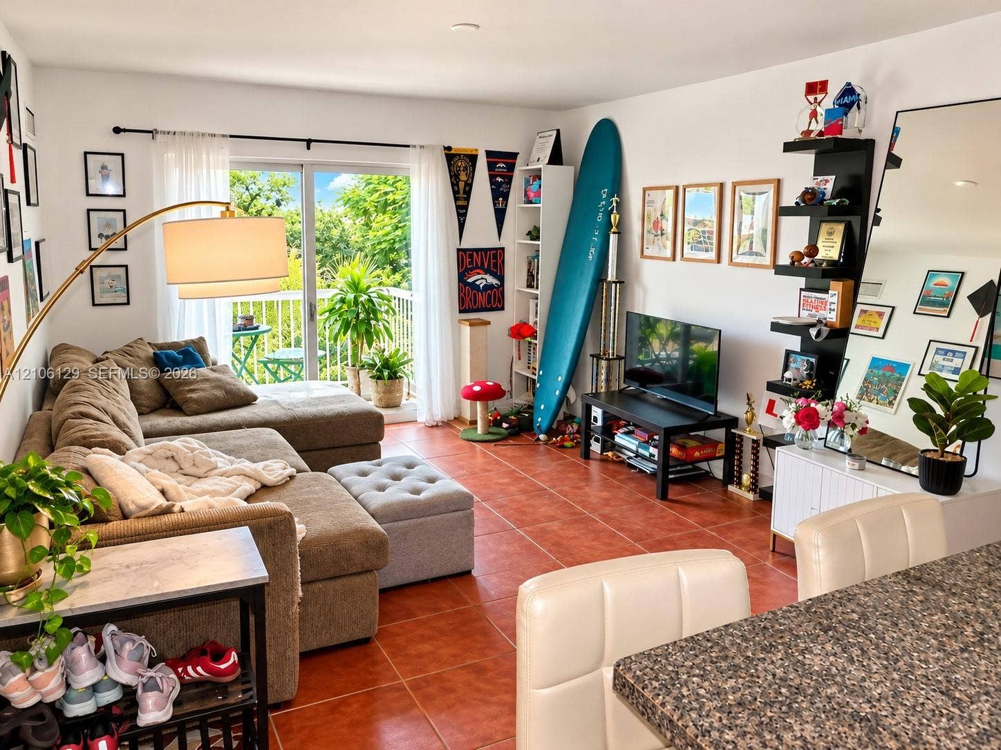 2740 SW 28th Terrace, #307, Miami, FL 33133 Ceramic tile flooring, sliding glass patio door, and balcony with metal railing