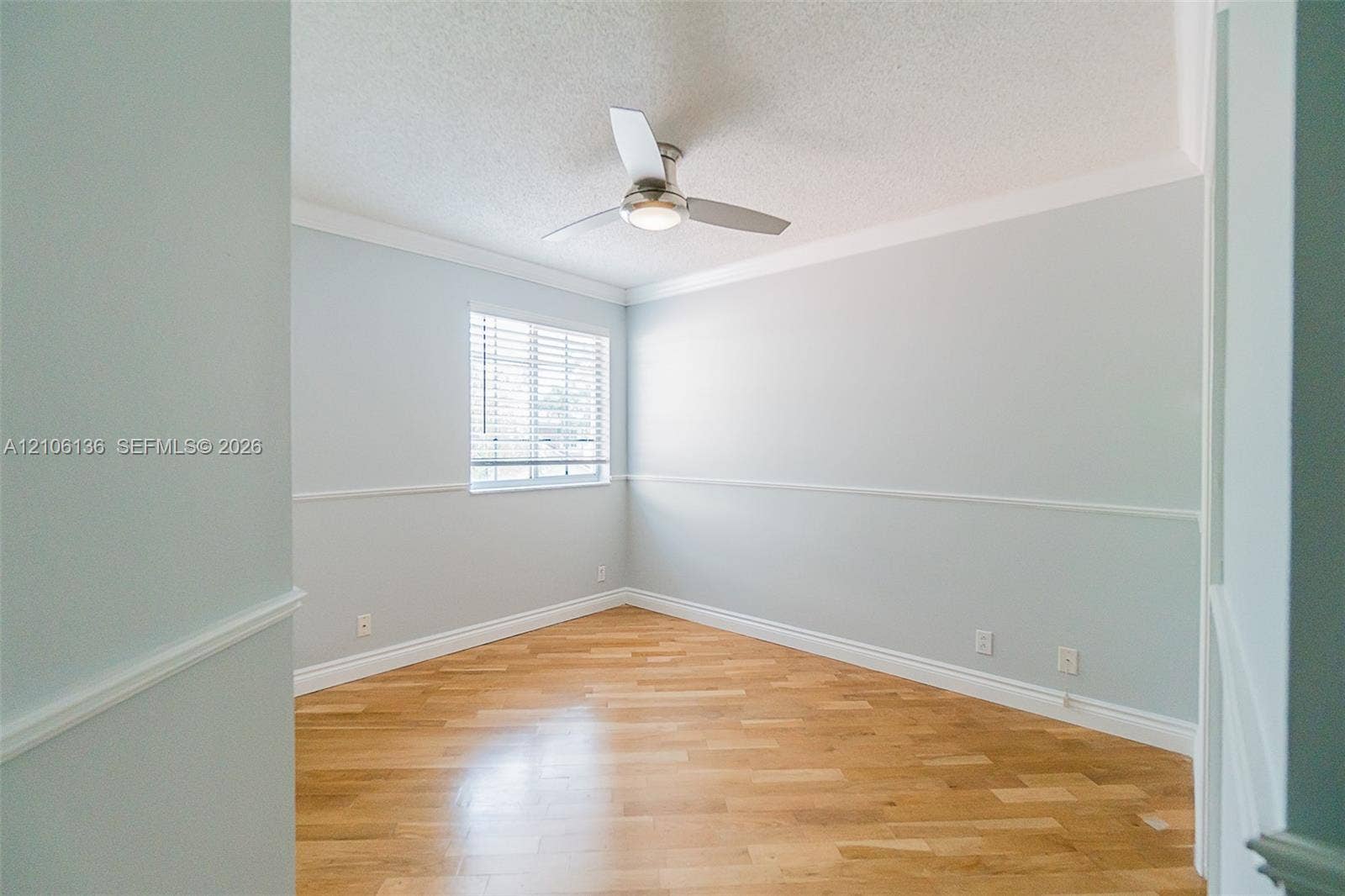 3713 San Simeon Circle, Weston, Weston, FL 33331 Room featuring wood-finish flooring, chair rail molding, crown molding, a window with horizontal blinds, and a central ceiling fan