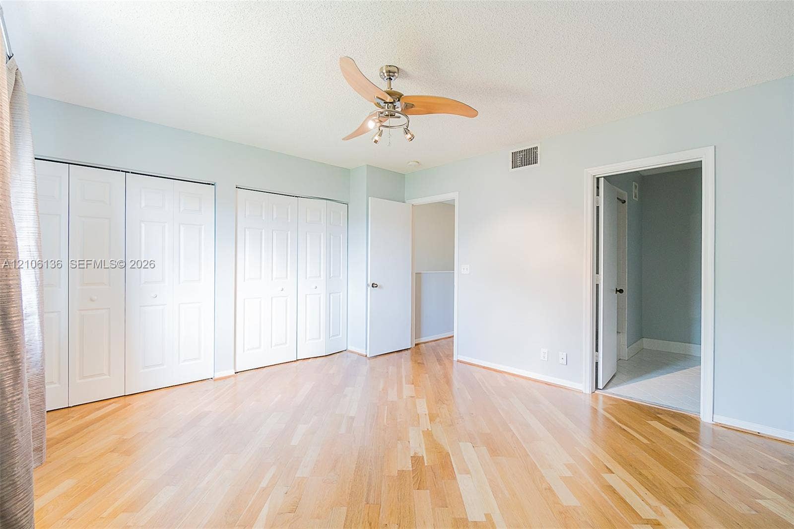 3713 San Simeon Circle, Weston, Weston, FL 33331 Wood-finish flooring, multi-panel closet doors, and a ceiling fan with integrated lighting