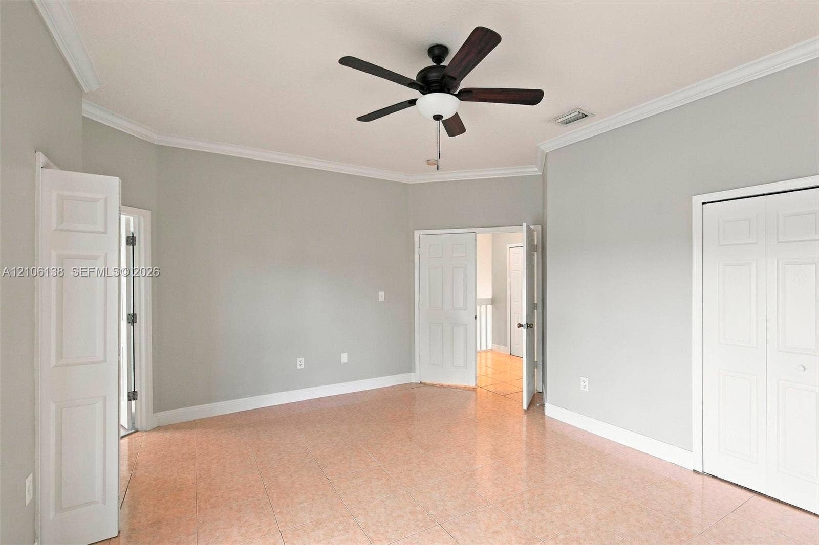 16119 SW 61st Lane, Miami, Miami, FL 33193 Neutral wall palette featuring crown molding, tile flooring, and a ceiling fan with integrated light fixture