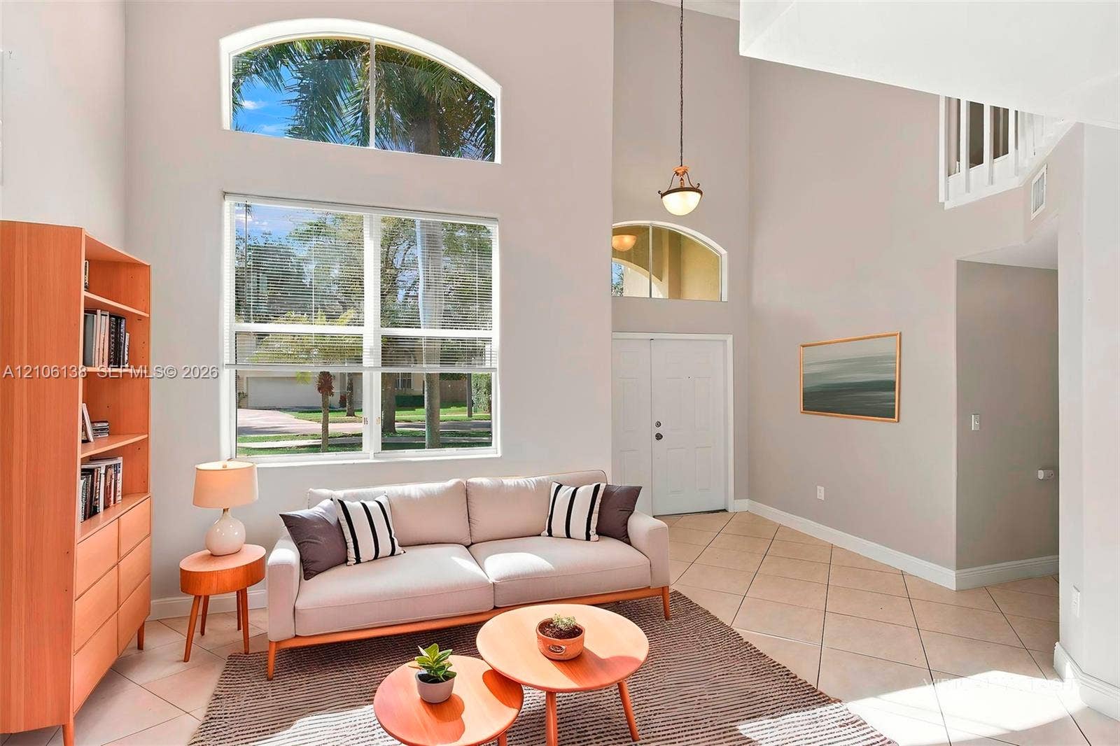16119 SW 61st Lane, Miami, Miami, FL 33193 Double-height ceilings, arched transom windows, tile flooring, and a suspended pendant light fixture