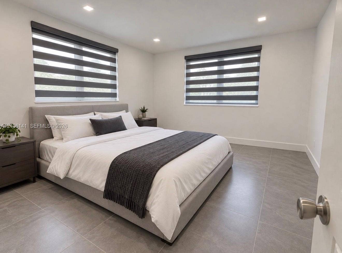 5190 E 10th Avenue, #1, Hialeah, Hialeah, FL 33013 Neutral interior space featuring large-format ceramic tile flooring, recessed ceiling lighting, and windows equipped with dual-layered roller shades