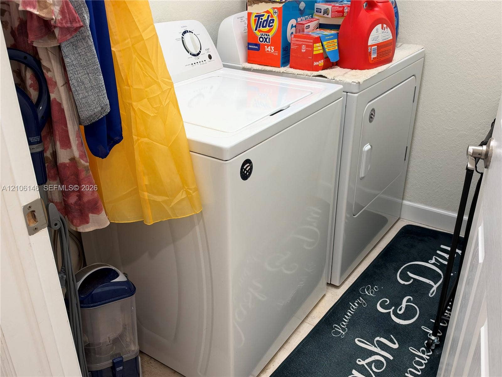 3259 W 100th Terrace, Hialeah, FL 33018 Laundry space featuring a top-load washer and side-by-side dryer