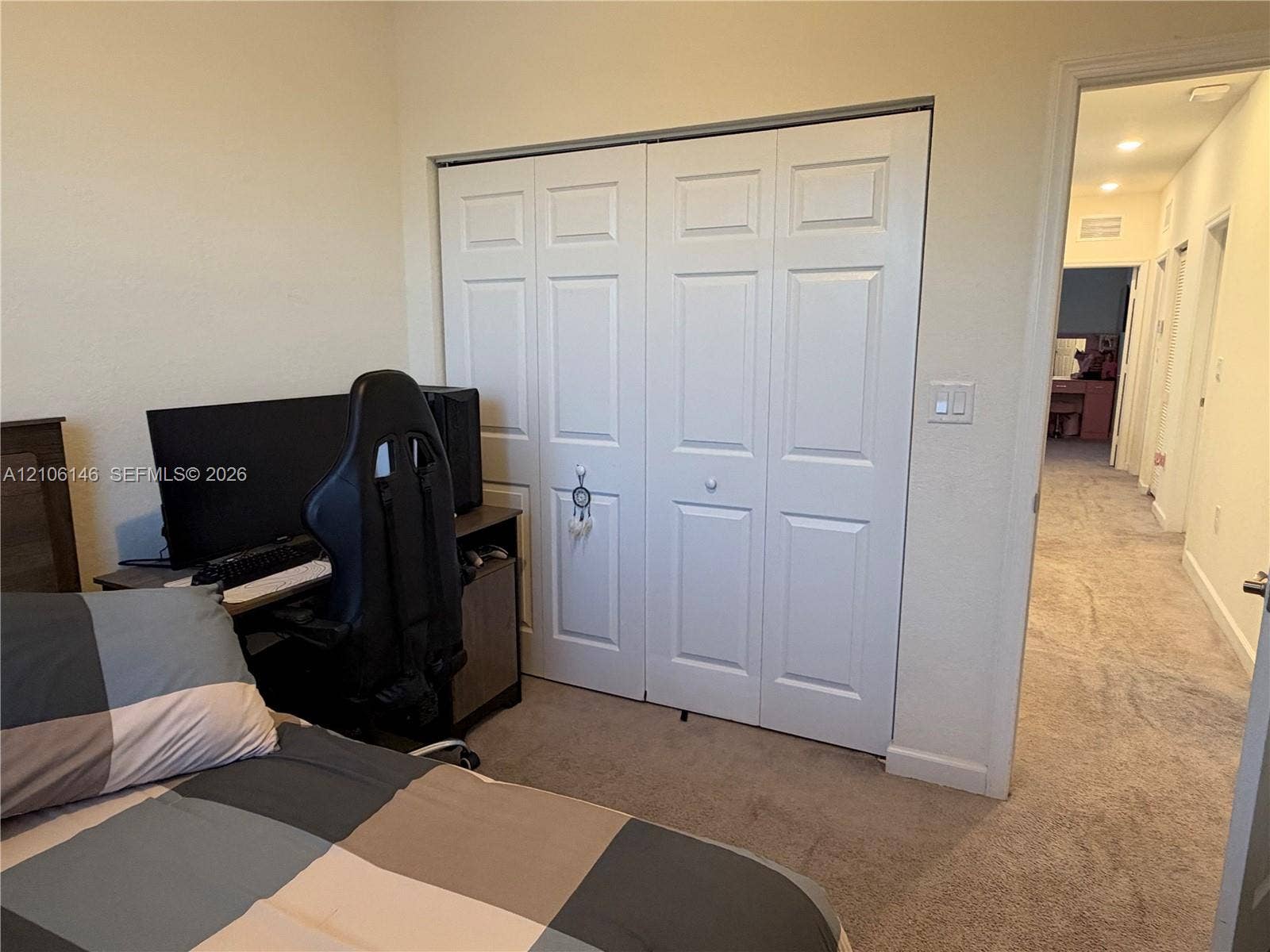 3259 W 100th Terrace, Hialeah, FL 33018 Room featuring carpeting and a double-door closet with raised-panel detailing