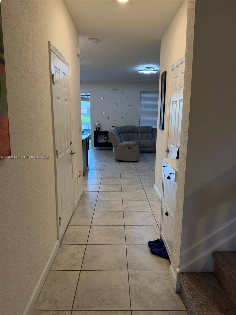 3259 W 100th Terrace, Hialeah, FL 33018 Ceramic tile flooring, white six-panel interior doors, and neutral wall tones