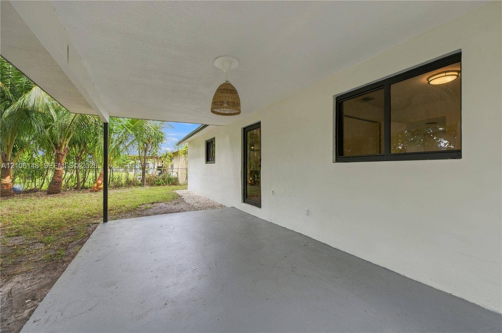 2920 Dorson Way, Delray Beach, FL 33445 Covered patio featuring a smooth concrete floor, recessed wall-mounted lighting, and a pendant fixture