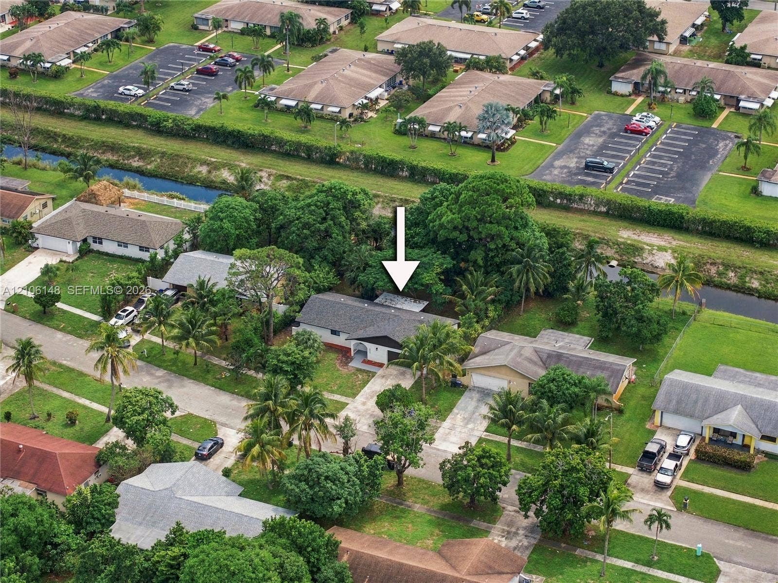 2920 Dorson Way, Delray Beach, FL 33445 Single-story residence featuring a shingle roof, concrete driveway, and mature landscaping