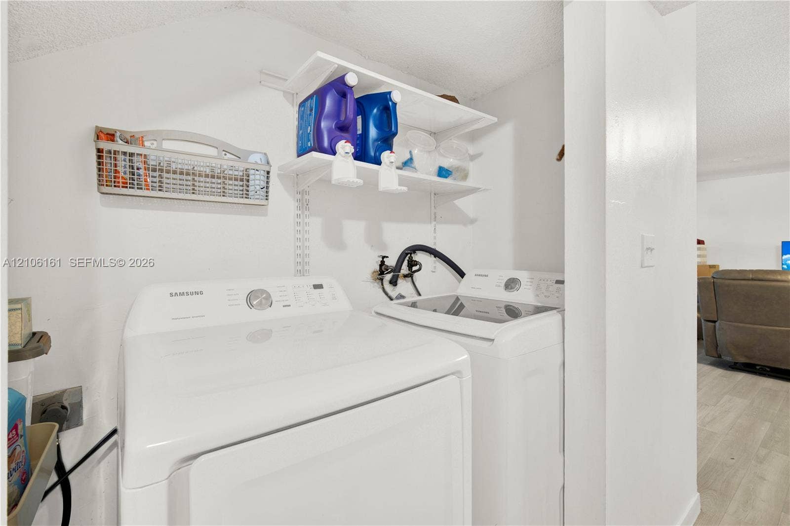 15460 SW 82nd Lane, #403, Miami, Miami, FL 33193 Laundry area featuring white top-loading washer and dryer with adjustable wall-mounted shelving