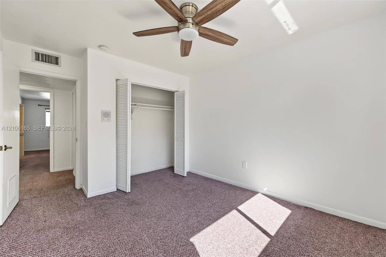 7205 W 3rd Avenue, #1, Hialeah, Hialeah, FL 33014 Interior room featuring wall-to-wall carpeting, a ceiling fan with integrated lighting, and a reach-in closet with louvered doors