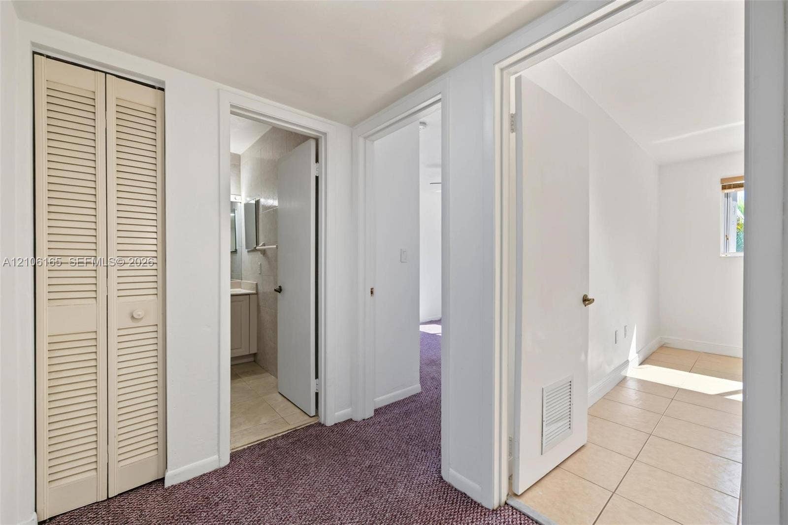 7205 W 3rd Avenue, #1, Hialeah, Hialeah, FL 33014 Louvered bi-fold closet doors, neutral wall finish, and low-pile carpeted flooring