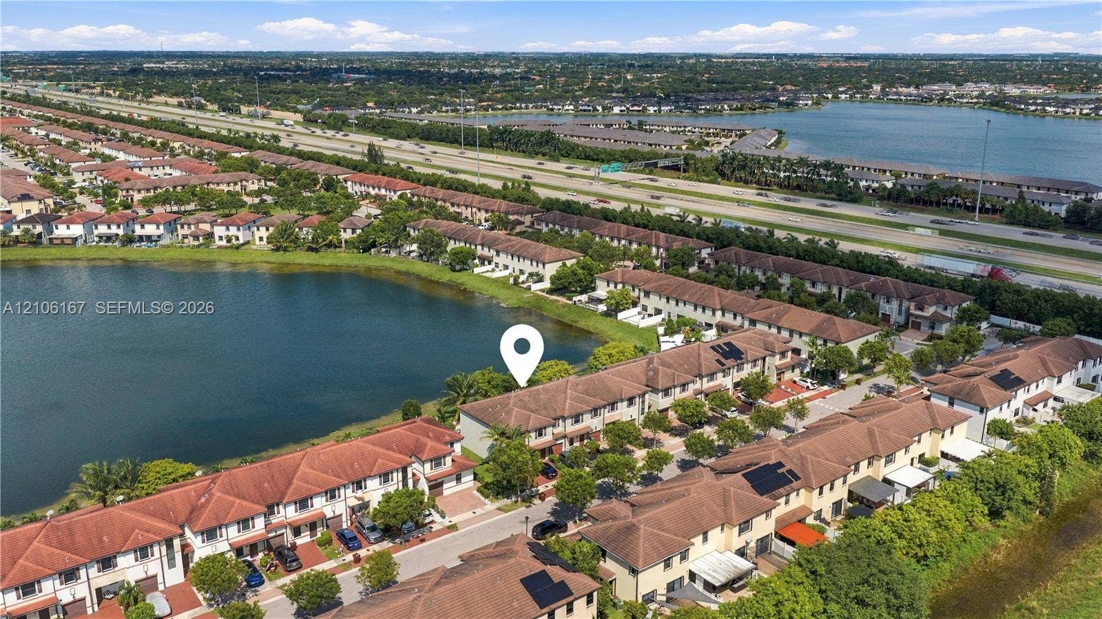 3277 W 100th Terrace, Hialeah, FL 33018 Aerial perspective of a multi-unit property featuring tile roofing and proximity to a waterfront