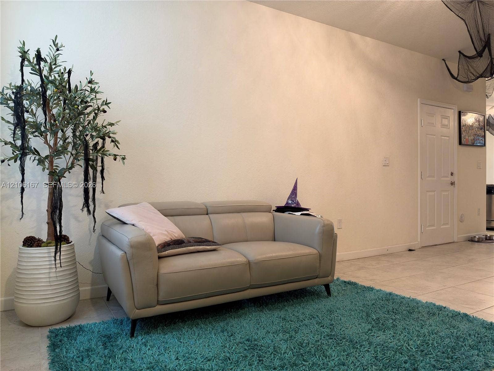 3277 W 100th Terrace, Hialeah, FL 33018 Large format floor tiles, neutral wall finish, and a six-panel interior door