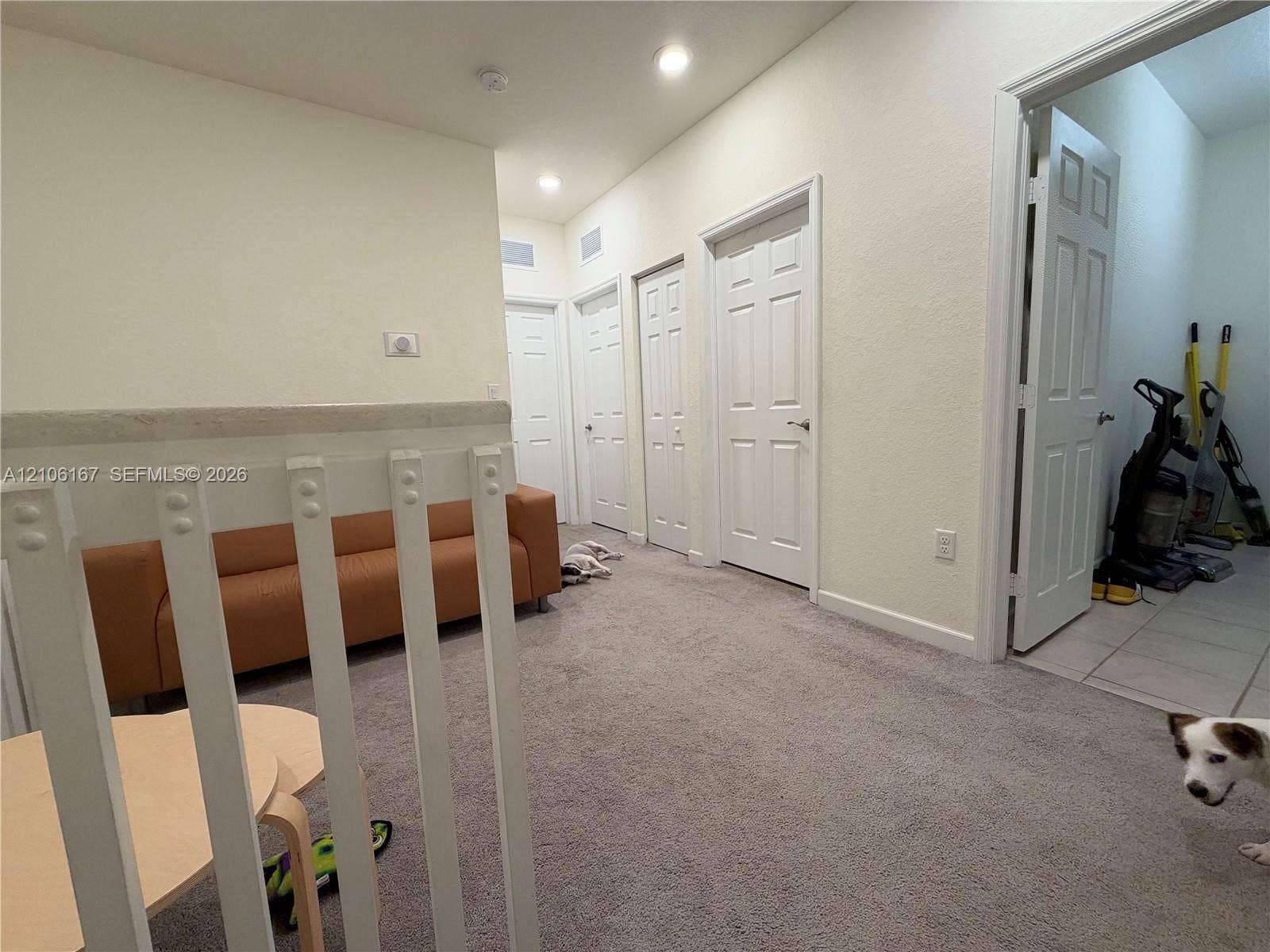 3277 W 100th Terrace, Hialeah, FL 33018 Interior space featuring neutral wall tones, wall-to-wall carpeting, recessed ceiling lighting, and multiple interior paneled doors