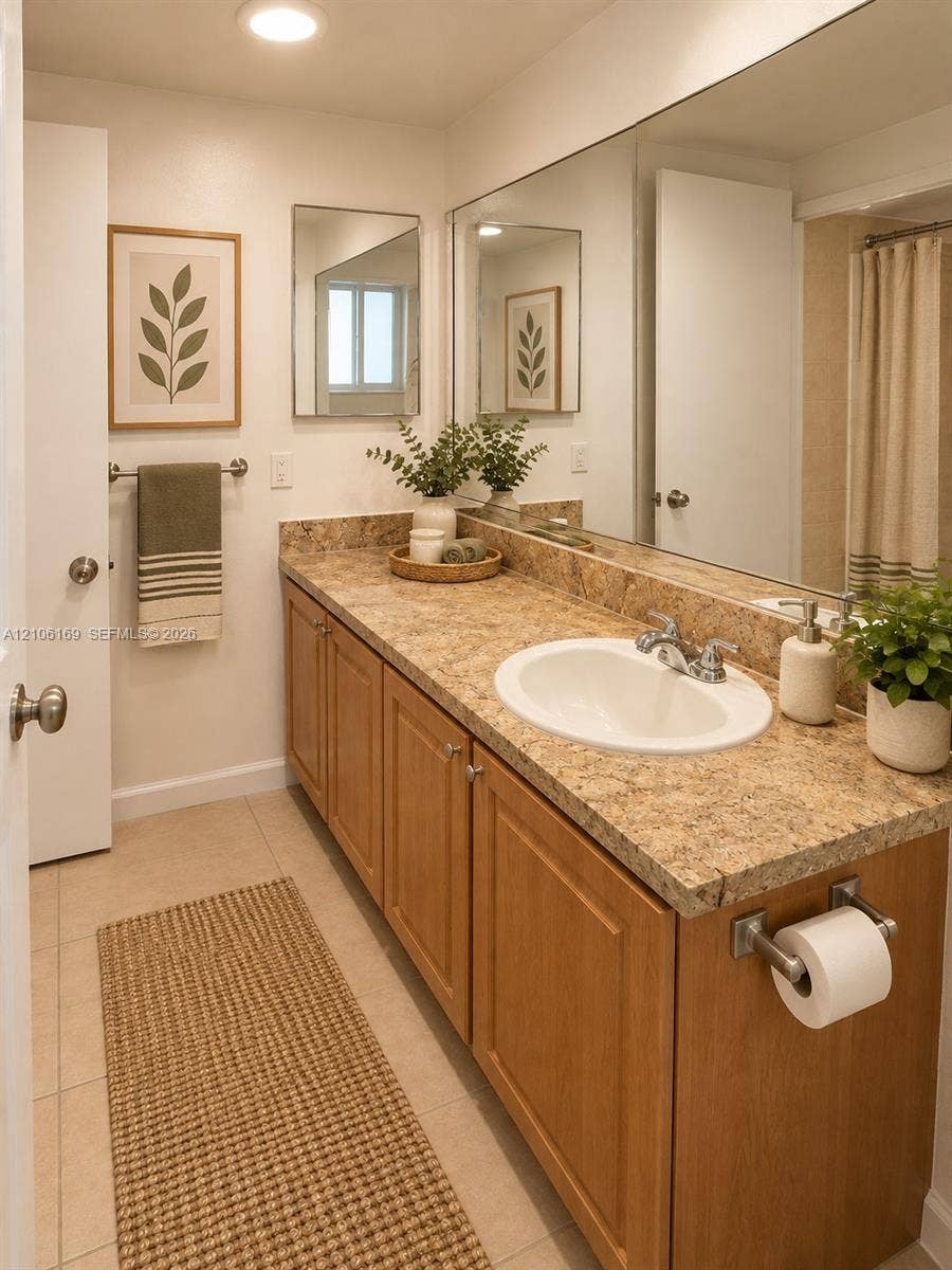 10820 SW 200th Drive, #162, Cutler Bay, Cutler Bay, FL 33157 Bathroom featuring a wood-finish vanity with a stone-composite countertop, an integrated oval basin, a full-width wall mirror, and tile flooring