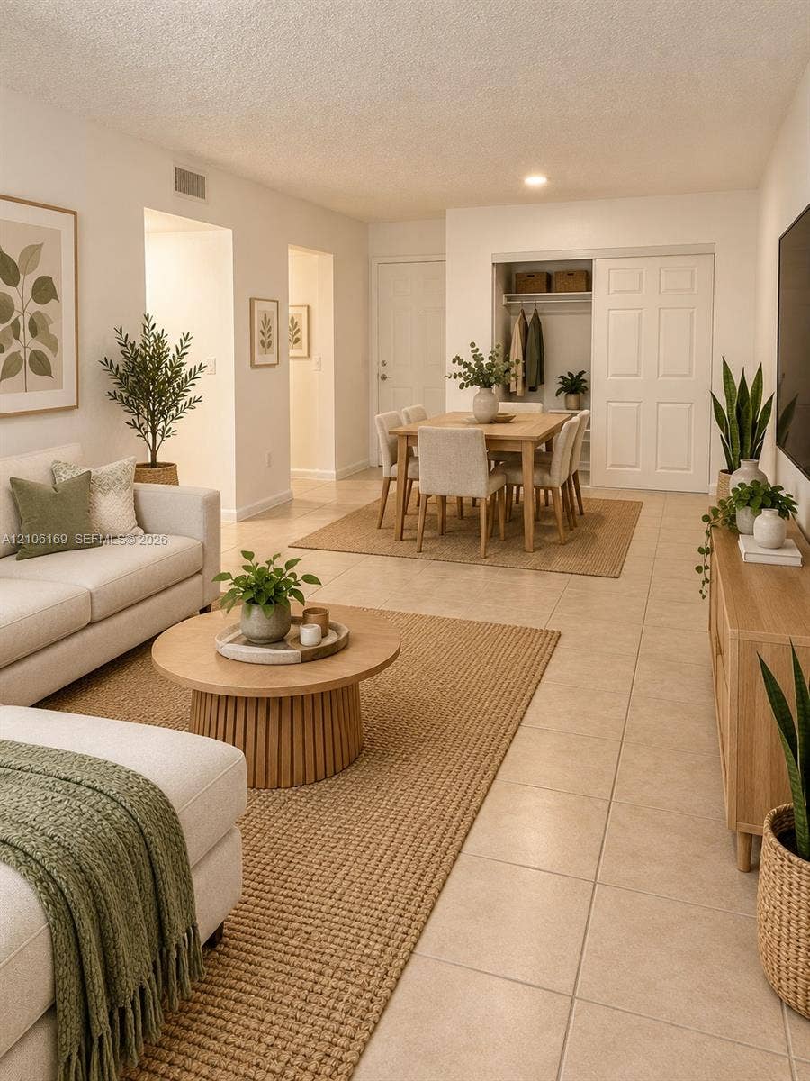 10820 SW 200th Drive, #162, Cutler Bay, Cutler Bay, FL 33157 Open living area featuring large-format ceramic tile flooring, neutral wall finishes, and a built-in closet with six-panel doors