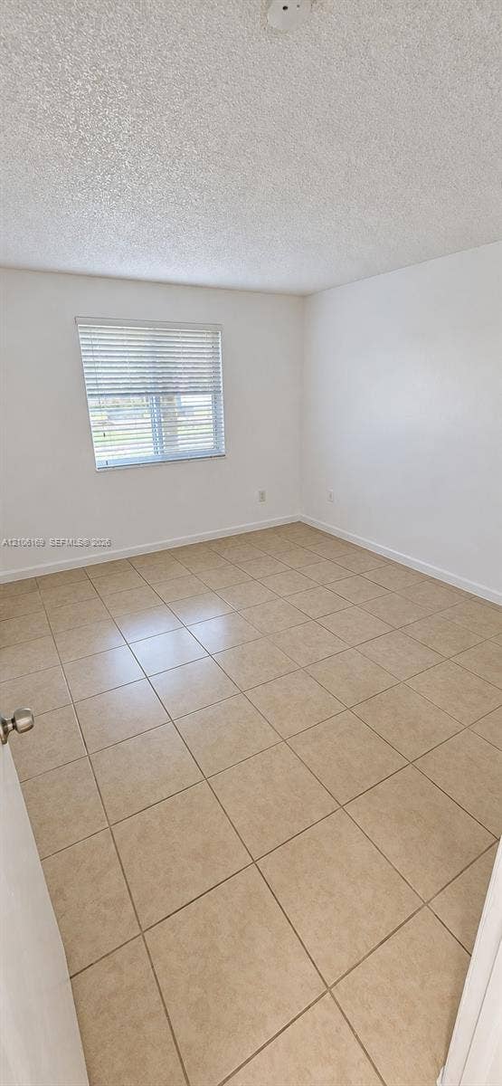 10820 SW 200th Drive, #162, Cutler Bay, Cutler Bay, FL 33157 Neutral-toned tile flooring, white wall finish, and a window with installed horizontal blinds