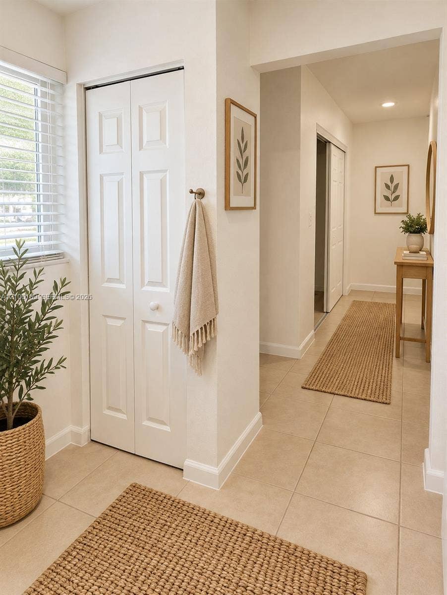 10820 SW 200th Drive, #162, Cutler Bay, Cutler Bay, FL 33157 Neutral tile flooring, white six-panel bifold closet doors, and recessed ceiling lighting
