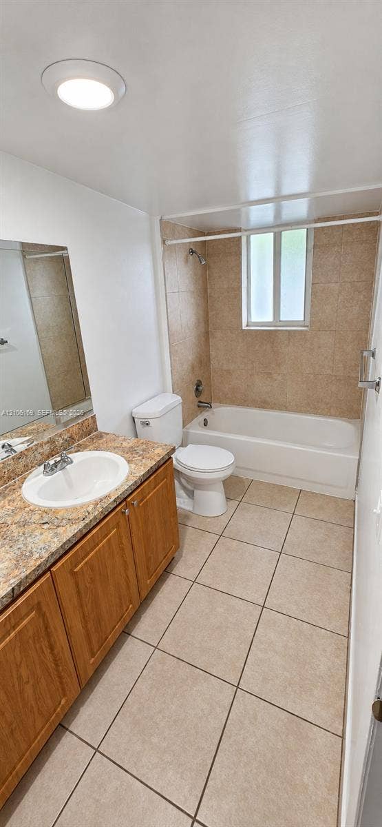 10820 SW 200th Drive, #162, Cutler Bay, Cutler Bay, FL 33157 Bathroom featuring a vanity with stone-finish countertop, integrated sink, tile flooring, bathtub with tiled surround, and recessed ceiling lighting