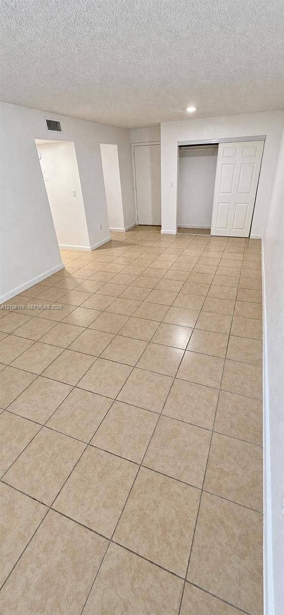 10820 SW 200th Drive, #162, Cutler Bay, Cutler Bay, FL 33157 Neutral-toned ceramic tile flooring, recessed ceiling lighting, and a reach-in closet featuring a sliding paneled door