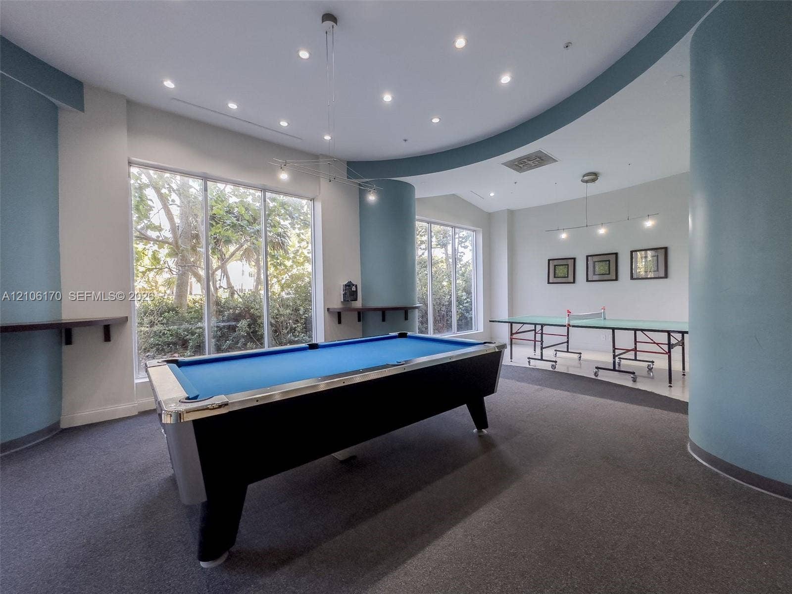 4001 S Ocean Drive, #12B, Hollywood, Hollywood, FL 33019 Spacious room featuring curved architectural walls, recessed ceiling lighting, wall-mounted shelving, and floor-to-ceiling windows