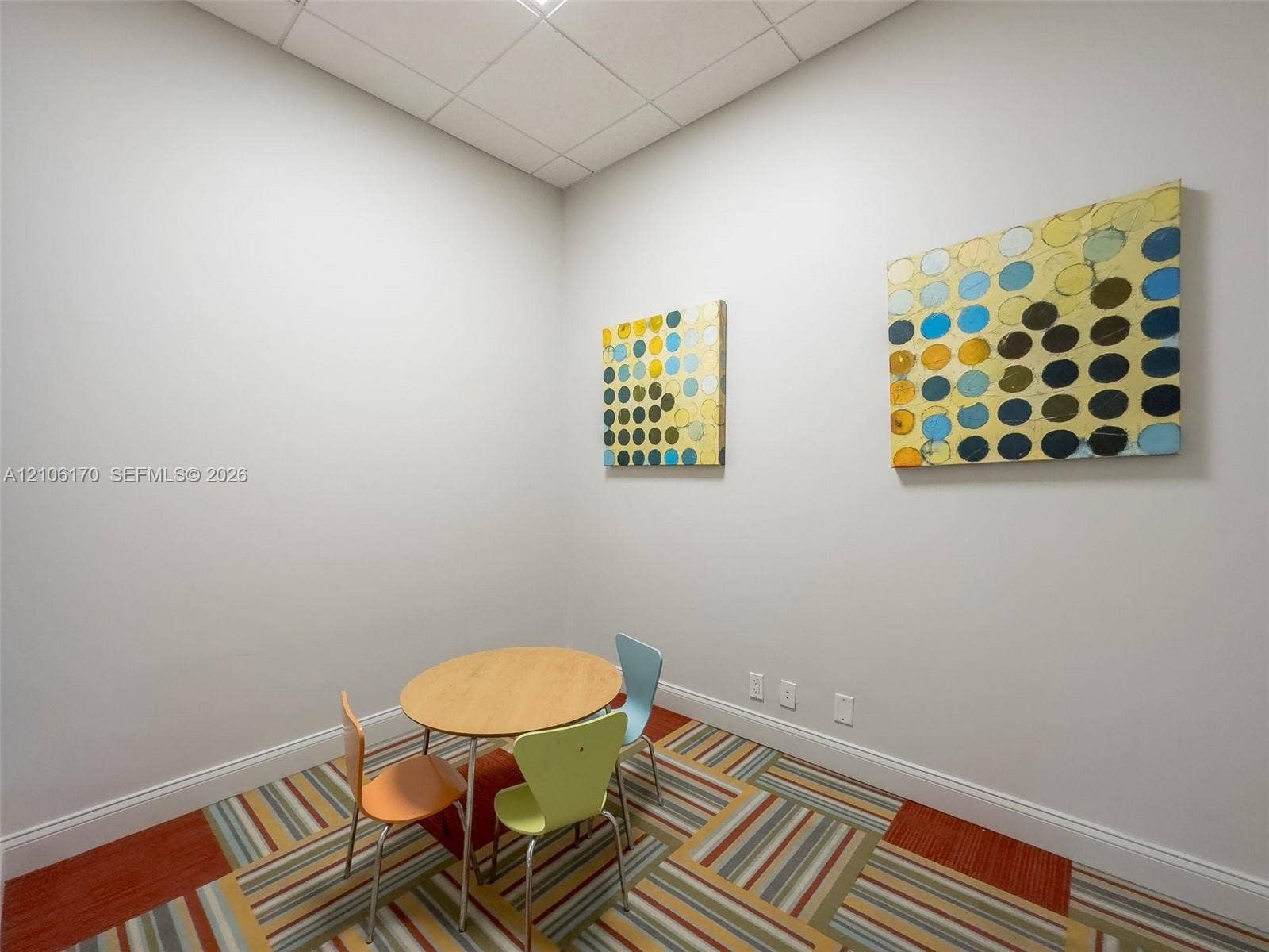 4001 S Ocean Drive, #12B, Hollywood, Hollywood, FL 33019 Interior room featuring neutral wall paint, drop-ceiling panels, and patterned carpeted flooring