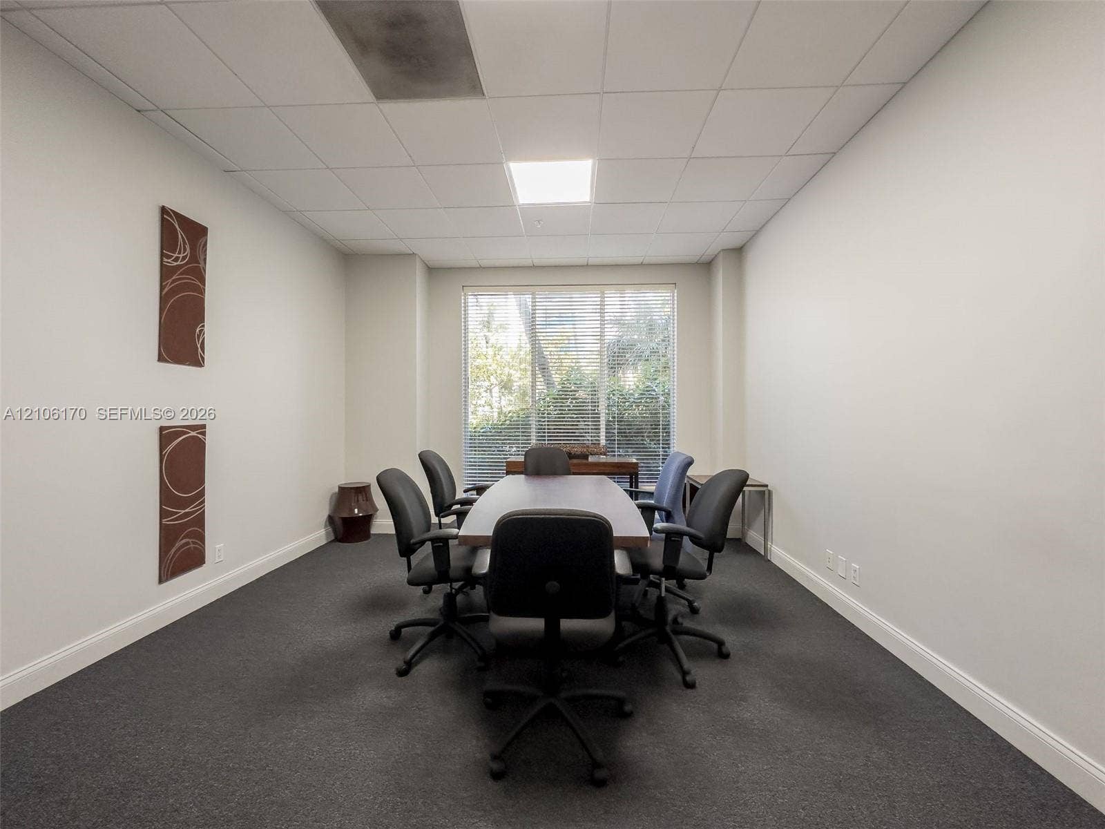 4001 S Ocean Drive, #12B, Hollywood, Hollywood, FL 33019 Enclosed room featuring neutral-toned walls, charcoal carpeting, recessed ceiling lighting, and a large window with horizontal blinds
