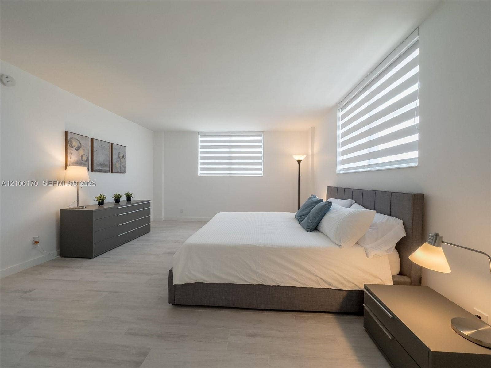 4001 S Ocean Drive, #12B, Hollywood, Hollywood, FL 33019 Neutral interior featuring wood-finish flooring, white walls, and dual-layered roller shades
