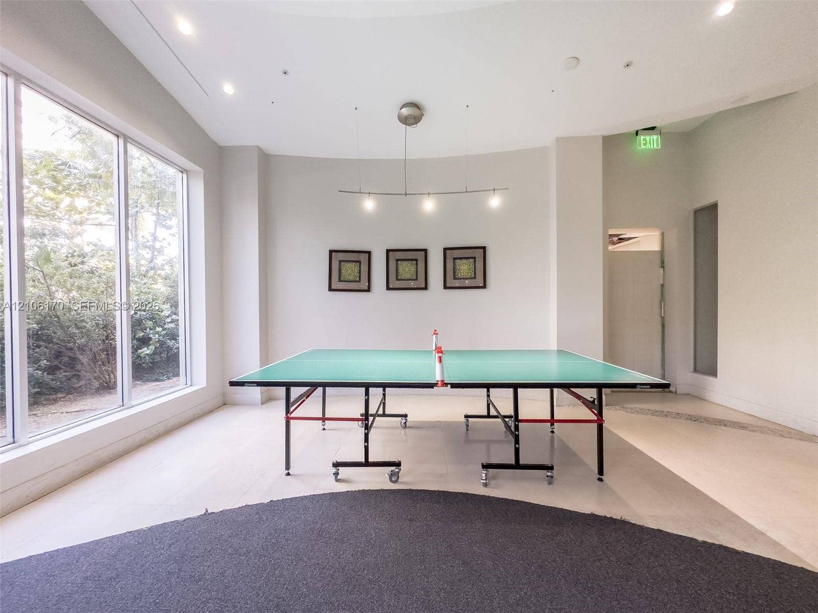 4001 S Ocean Drive, #12B, Hollywood, Hollywood, FL 33019 Expansive interior room featuring floor-to-ceiling windows, recessed lighting, curved wall architecture, and a modern multi-pendant light fixture