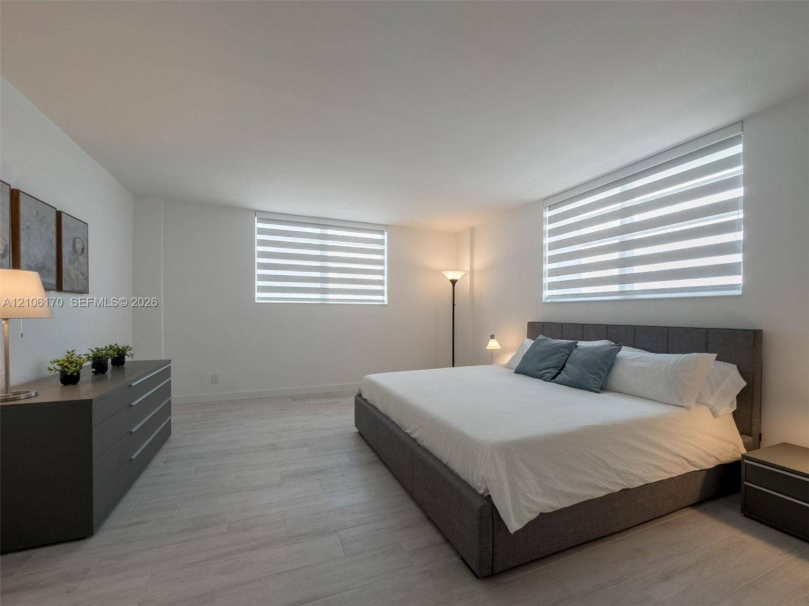 4001 S Ocean Drive, #12B, Hollywood, Hollywood, FL 33019 Spacious room featuring wood-finish flooring, neutral wall color, and adjustable horizontal dual-layered roller shades