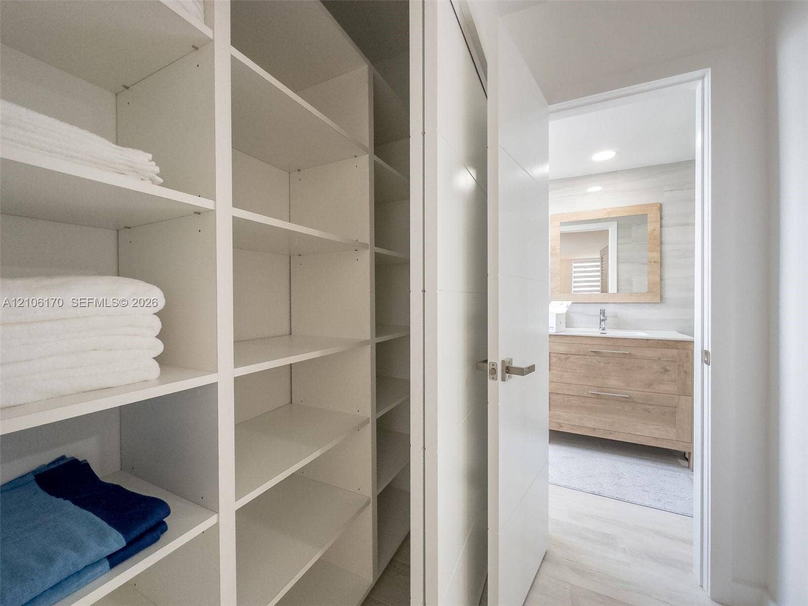 4001 S Ocean Drive, #12B, Hollywood, Hollywood, FL 33019 Built-in shelving unit with white finish, wood-finish vanity with rectangular sink, framed mirror, and recessed lighting