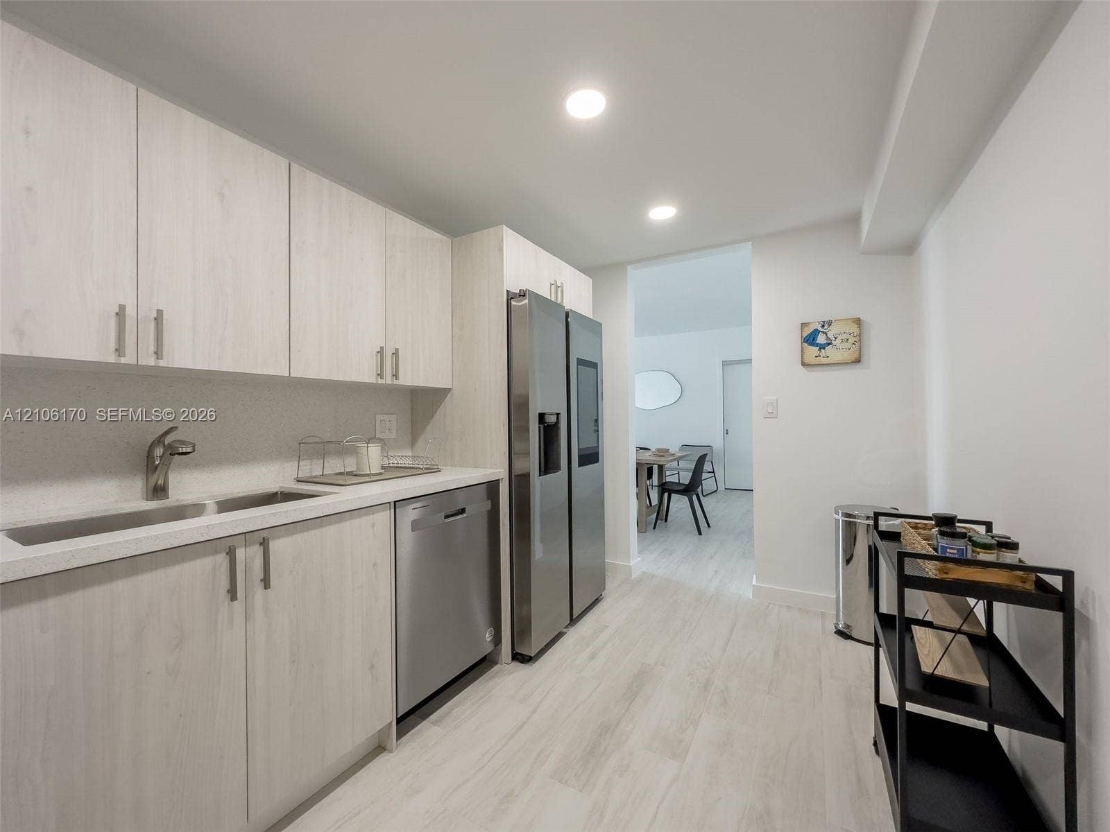 4001 S Ocean Drive, #12B, Hollywood, Hollywood, FL 33019 Kitchen featuring light wood-finish cabinetry, white solid-surface countertops, recessed lighting, and stainless steel appliances