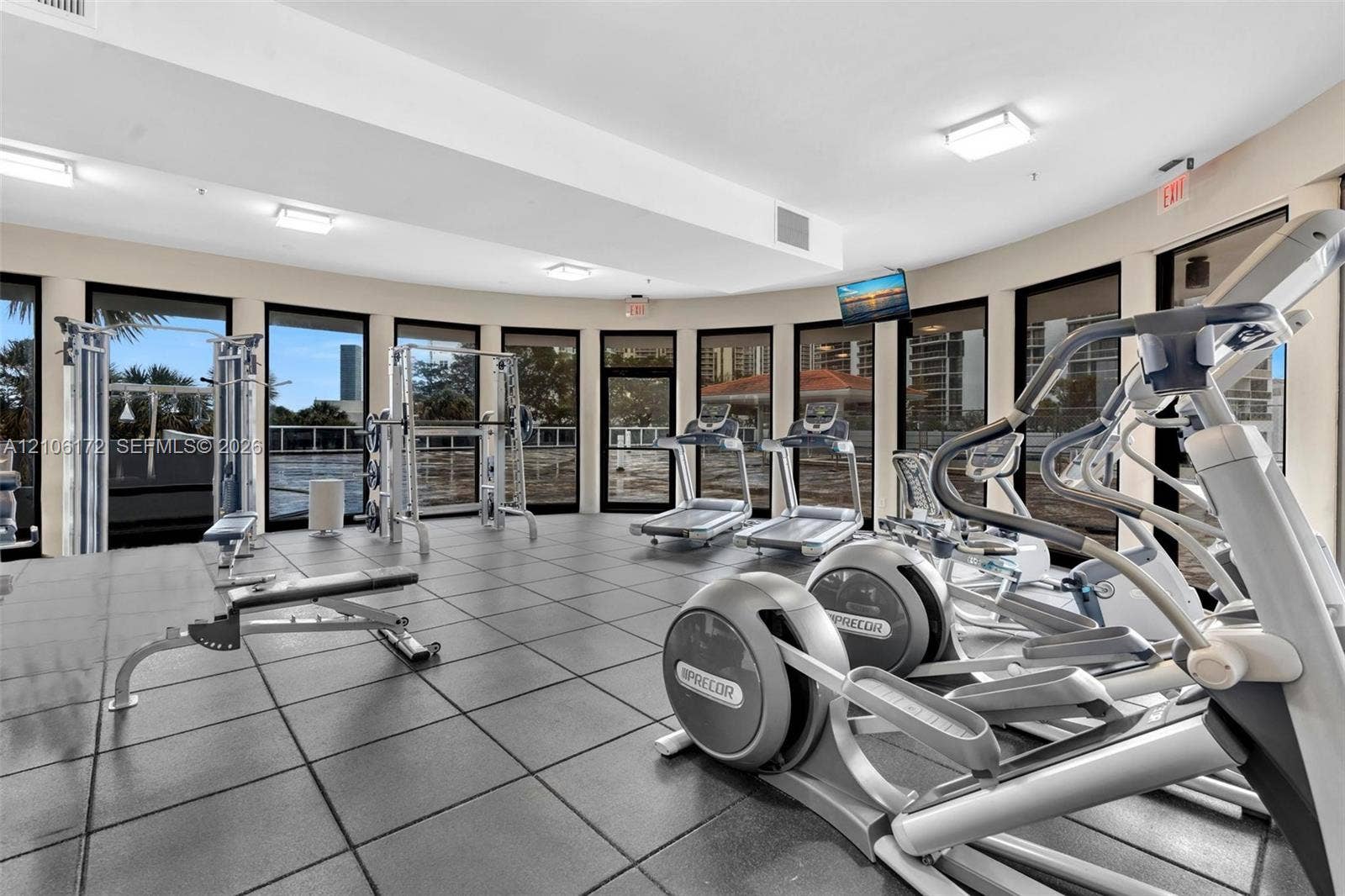 20515 E Country Club Drive, #246, Aventura, Aventura, FL 33180 Spacious fitness room featuring rubberized tile flooring, floor-to-ceiling glass paneling, and a semi-circular wall configuration