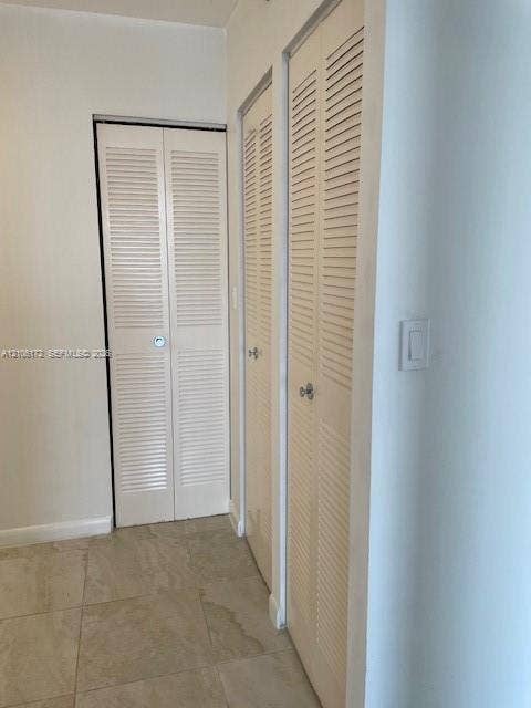 20515 E Country Club Drive, #246, Aventura, Aventura, FL 33180 Large-format neutral tile flooring and multiple bi-fold louvered closet doors