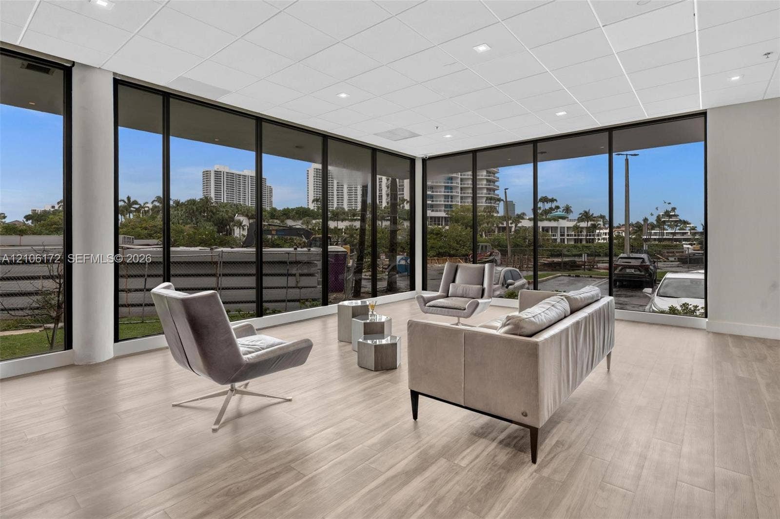 20515 E Country Club Drive, #246, Aventura, Aventura, FL 33180 Open-concept room featuring floor-to-ceiling windows with black metal frames, wood-finish flooring, and recessed ceiling lighting