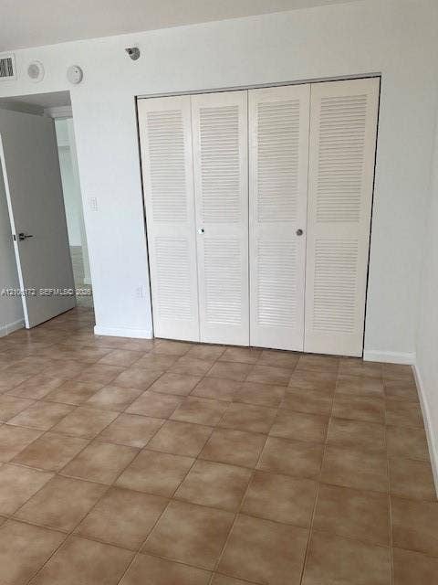 20515 E Country Club Drive, #246, Aventura, Aventura, FL 33180 Ceramic tile flooring throughout and white bi-fold louvered closet doors
