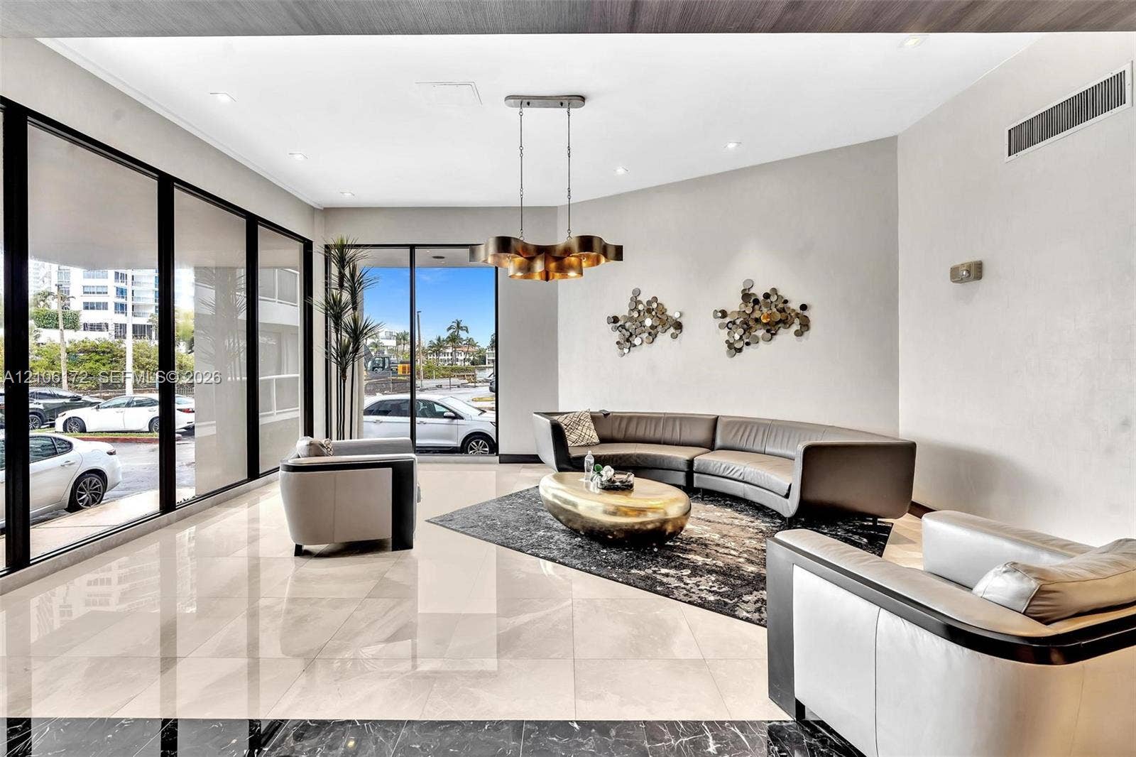 20515 E Country Club Drive, #246, Aventura, Aventura, FL 33180 Floor-to-ceiling windows, polished stone flooring, recessed ceiling lighting, and a multi-tiered metal chandelier