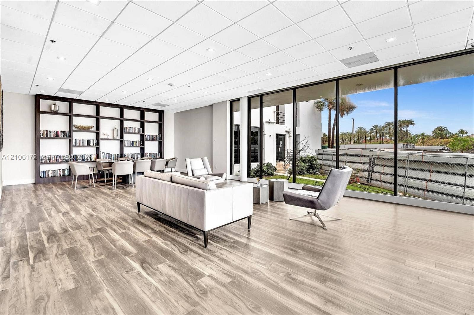 20515 E Country Club Drive, #246, Aventura, Aventura, FL 33180 Open-concept interior featuring wood-finish flooring, floor-to-ceiling glass panel windows, recessed lighting, drop ceiling panels, and built-in wall shelving