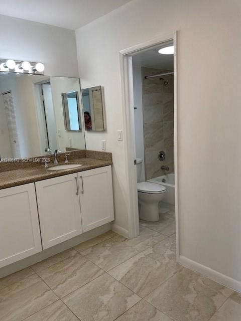 20515 E Country Club Drive, #246, Aventura, Aventura, FL 33180 Bathroom featuring white shaker-style cabinetry, a stone-finish countertop with an integrated basin, large-format tile flooring, and a tub-shower combination with tiled surround