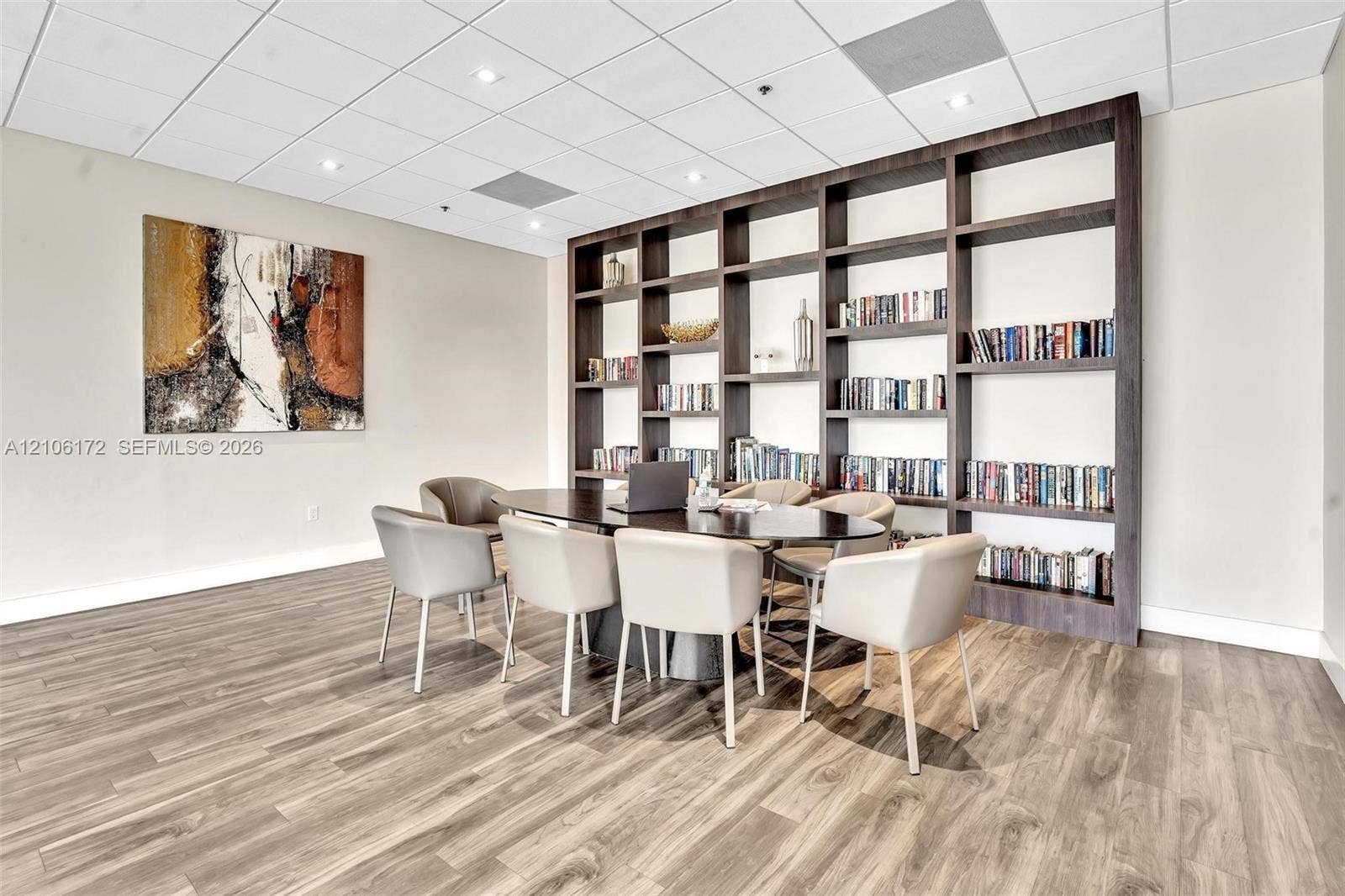 20515 E Country Club Drive, #246, Aventura, Aventura, FL 33180 Custom floor-to-ceiling built-in dark wood shelving, wood-finish flooring, and recessed ceiling lighting
