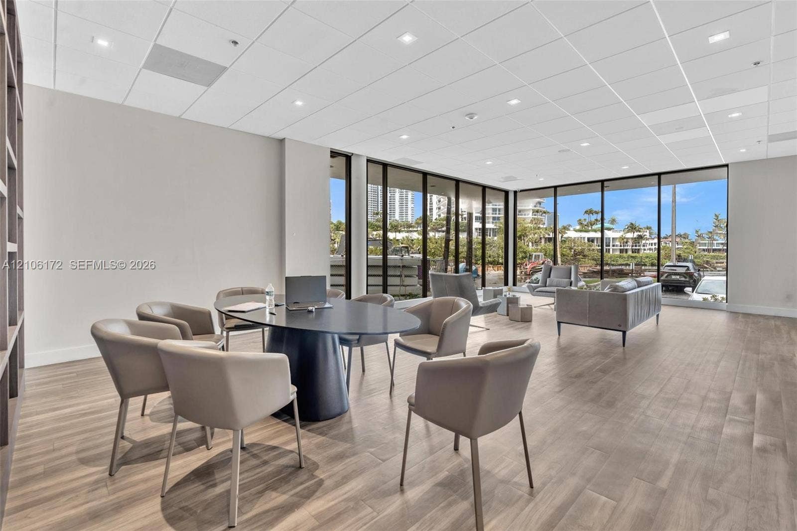20515 E Country Club Drive, #246, Aventura, Aventura, FL 33180 Open-concept interior featuring floor-to-ceiling windows, wood-finish flooring, recessed lighting, and built-in shelving