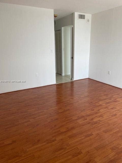 20515 E Country Club Drive, #246, Aventura, Aventura, FL 33180 Interior space featuring wood-finish flooring, white walls, and a louvered closet door