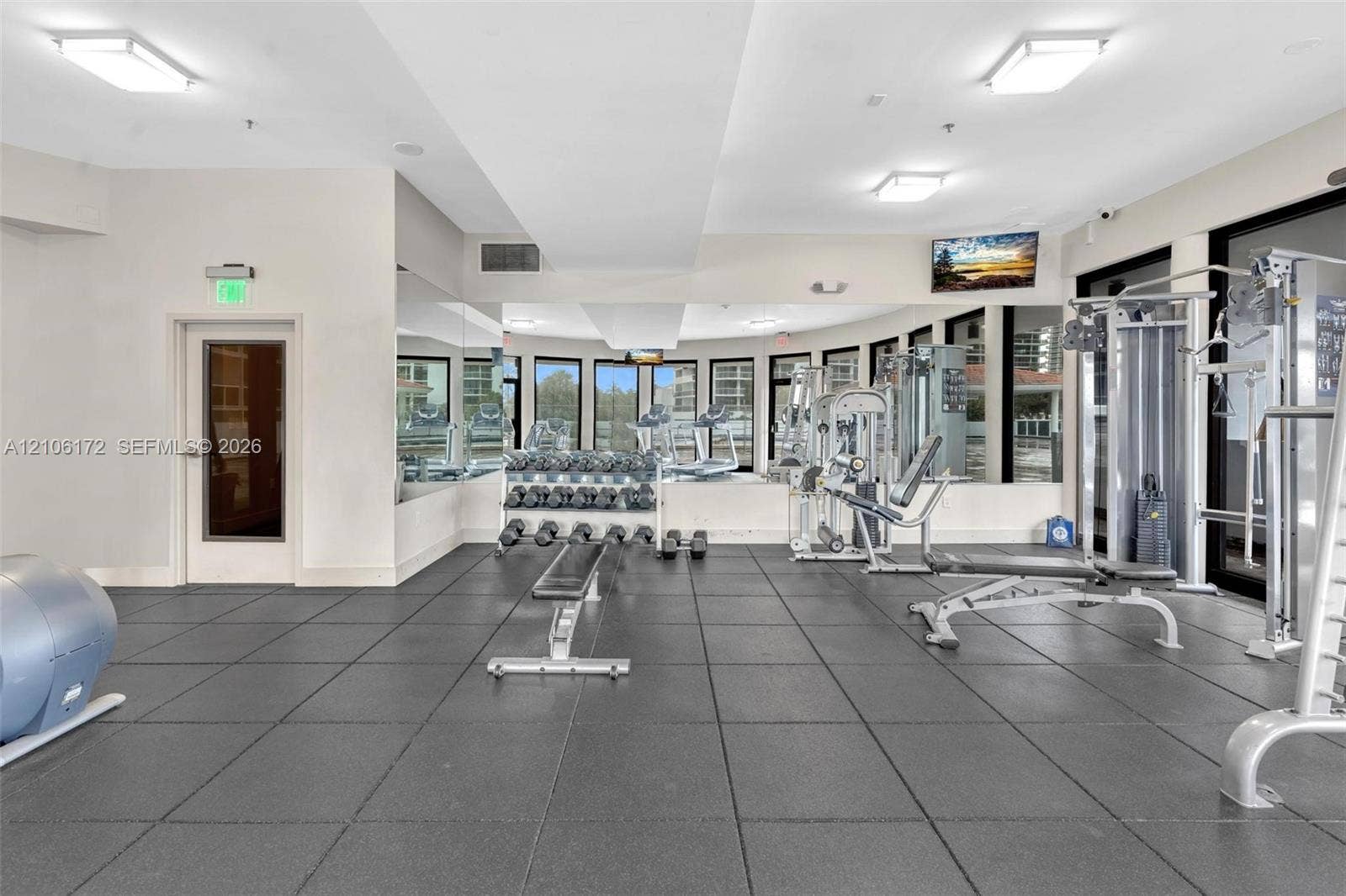 20515 E Country Club Drive, #246, Aventura, Aventura, FL 33180 Fitness center featuring rubberized tile flooring, floor-to-ceiling mirrors, recessed lighting, and multiple windows