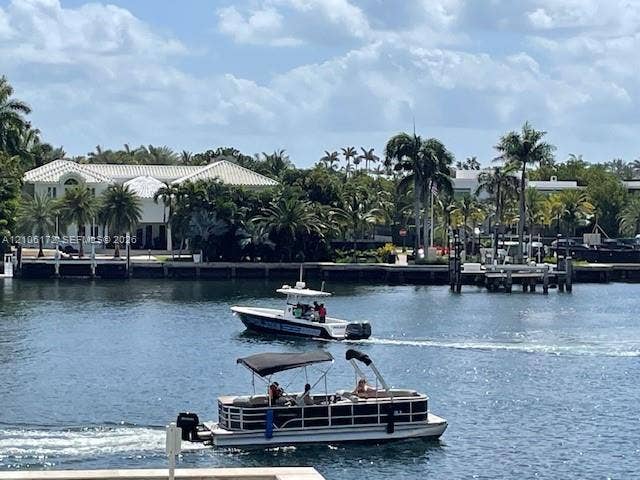 20515 E Country Club Drive, #246, Aventura, Aventura, FL 33180 Waterfront property featuring a private boat dock and mature palm tree landscaping