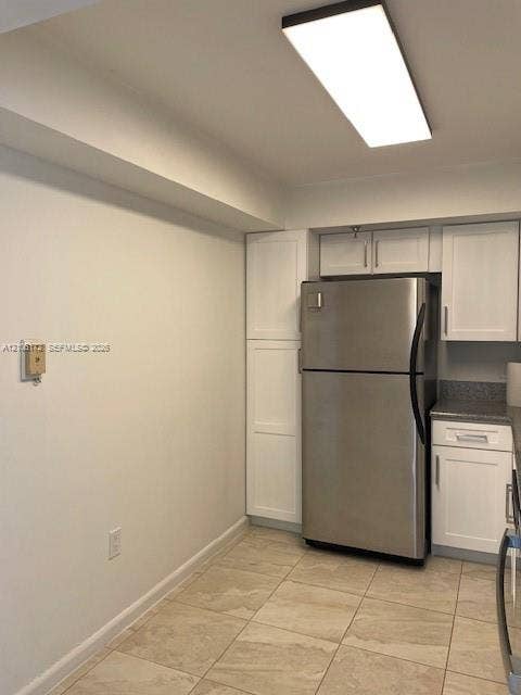 20515 E Country Club Drive, #246, Aventura, Aventura, FL 33180 Kitchen featuring white shaker-style cabinetry, stainless steel refrigerator, stone-composite countertops, and large-format tile flooring