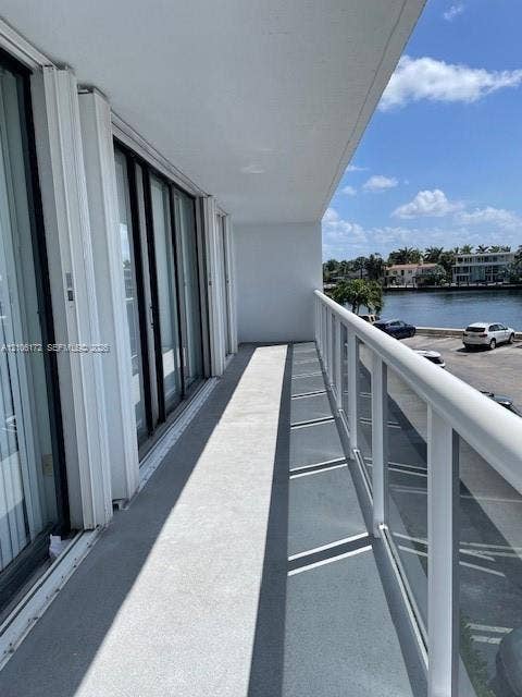 20515 E Country Club Drive, #246, Aventura, Aventura, FL 33180 Private balcony featuring a concrete floor, glass panel railing, and metal frame, accessible via multiple sliding glass doors