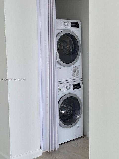 20515 E Country Club Drive, #246, Aventura, Aventura, FL 33180 Stacked white front-load washer and dryer set concealed by a folding white privacy door