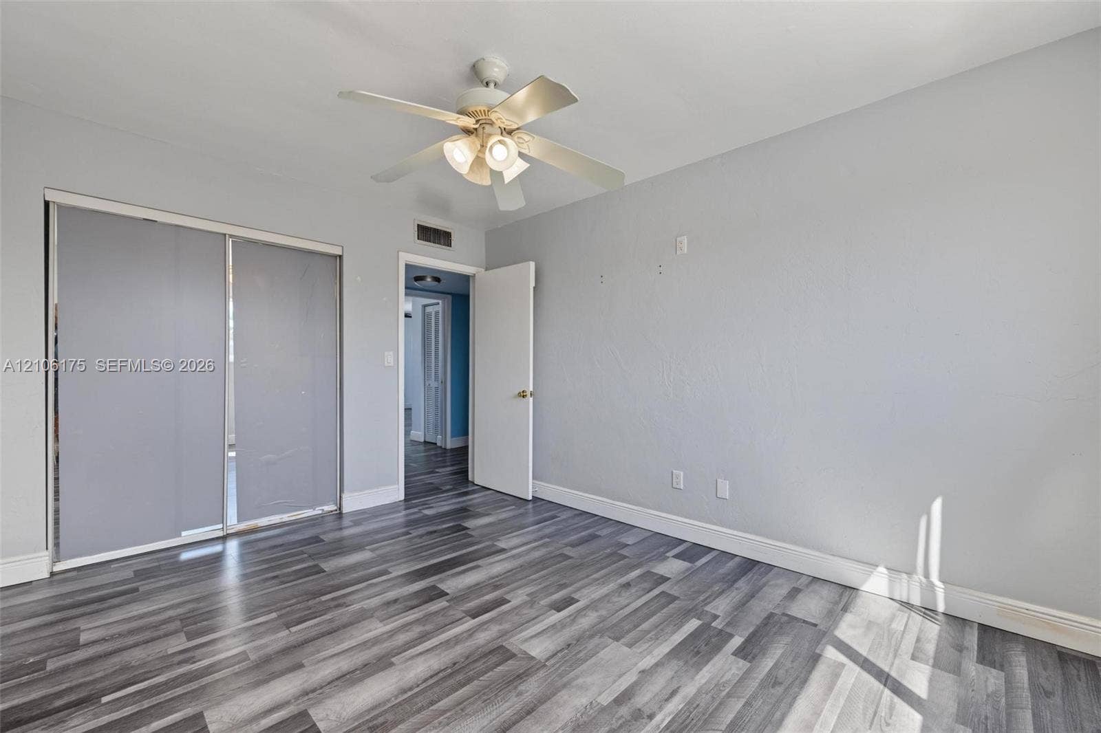 6905 W 2nd Way, #1, Hialeah, Hialeah, FL 33014 Wood-finish flooring, ceiling fan with integrated lighting, and dual-panel sliding closet doors