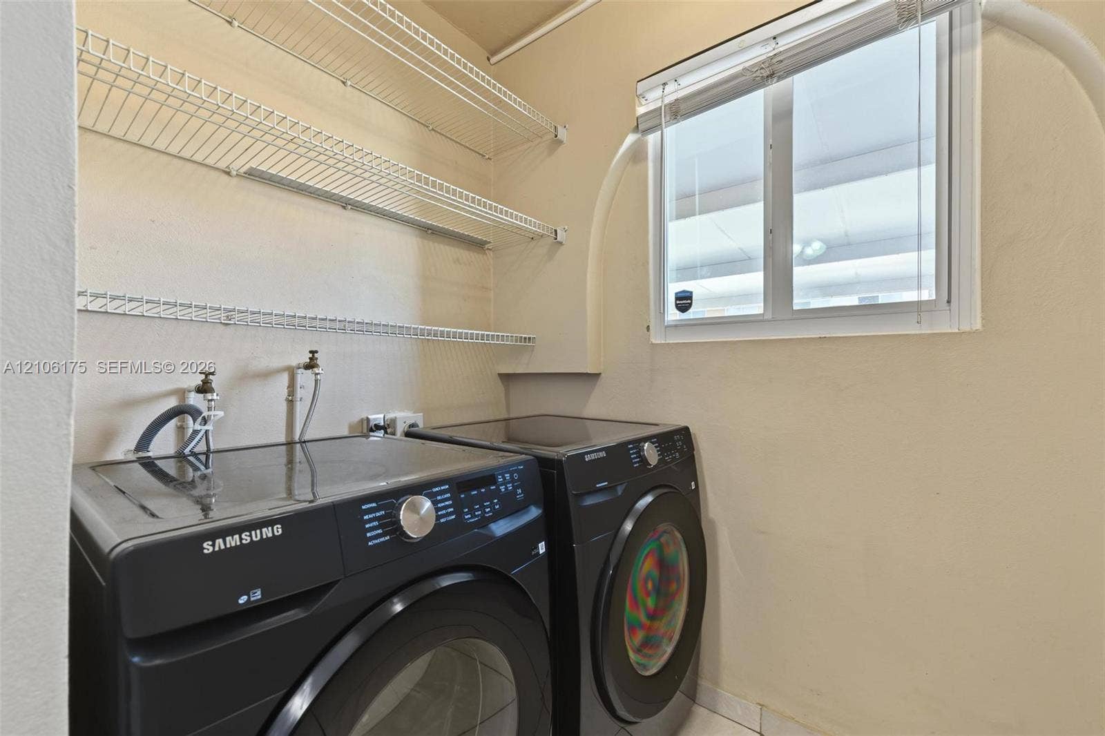6905 W 2nd Way, #1, Hialeah, Hialeah, FL 33014 Utility area featuring white wire shelving, a window with horizontal blinds, and dedicated water and electrical hookups