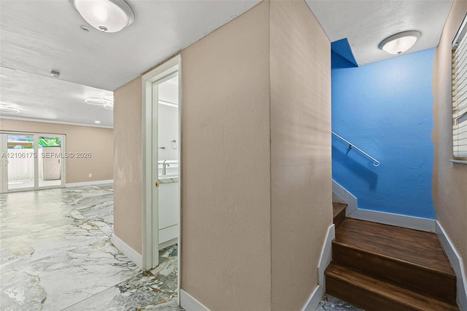 6905 W 2nd Way, #1, Hialeah, Hialeah, FL 33014 Interior space featuring stone-style flooring, wood-finish staircase treads, and a white metal handrail