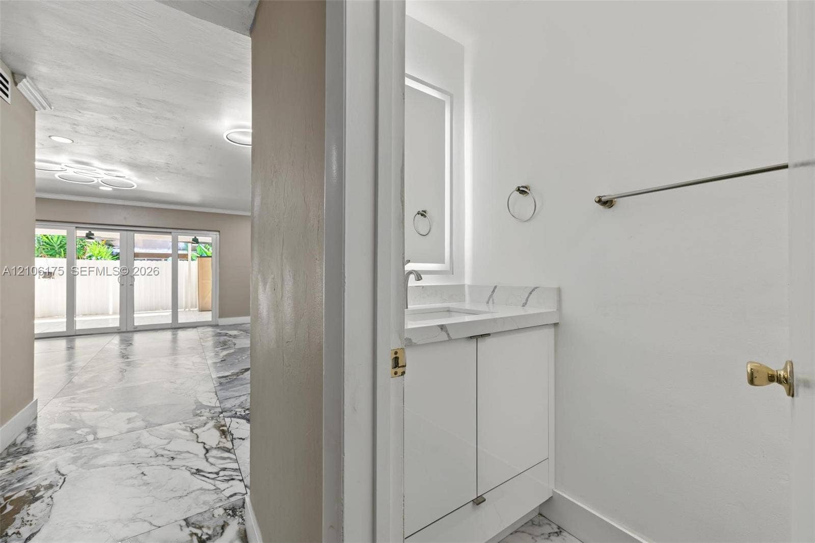 6905 W 2nd Way, #1, Hialeah, Hialeah, FL 33014 Bathroom vanity featuring a white cabinet, stone-finish countertop with integrated sink, and wall-mounted mirror